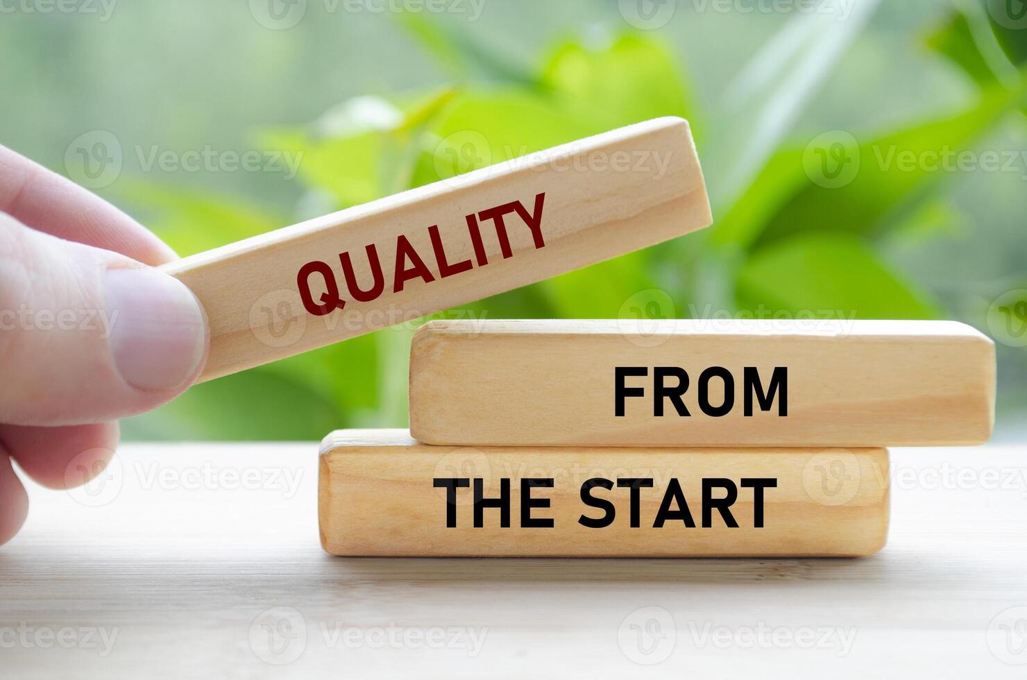 Quality From the start text on wooden blocks in hand shows a strong foundation laid from day one photo