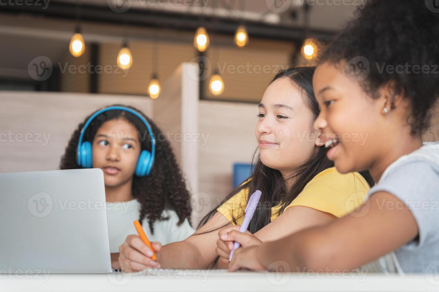 Diverse Group of Young Students Learning Together, Happy Girls Collaborating on a School Project, Teenagers Engaged in Online Education and Study photo