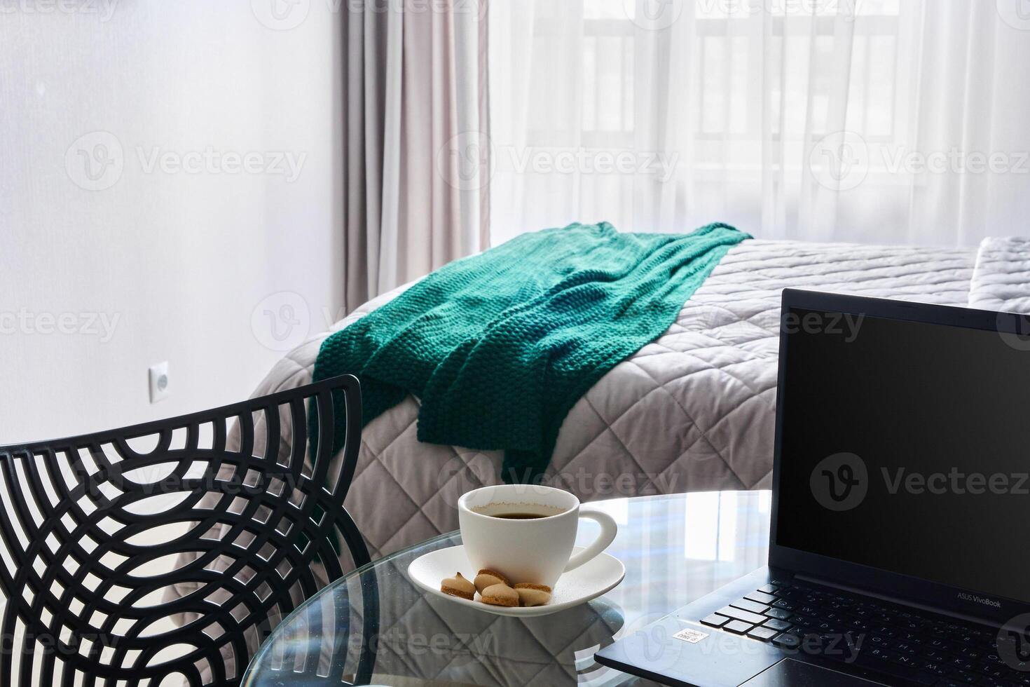 A Cozy and Inviting Workspace with a Warm Cup of Coffee and Soft Blanket in a Bright Room photo