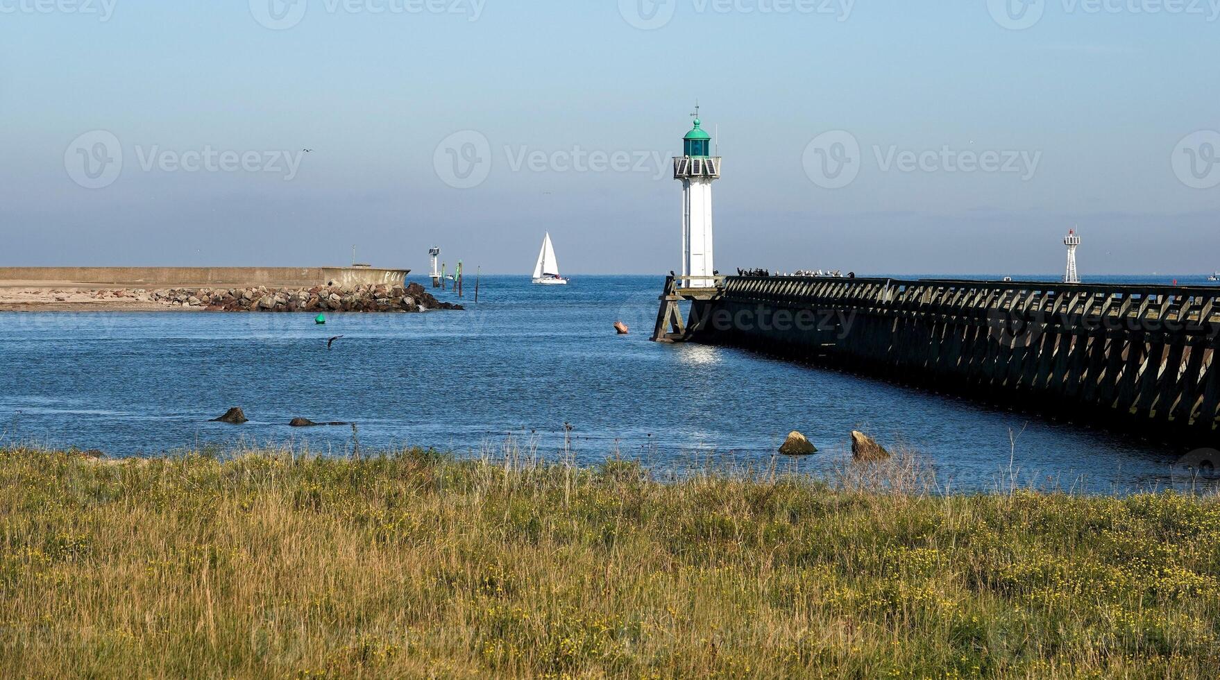 Overview of the pier, the lighthouse and the mouth of the port of Deauville photo