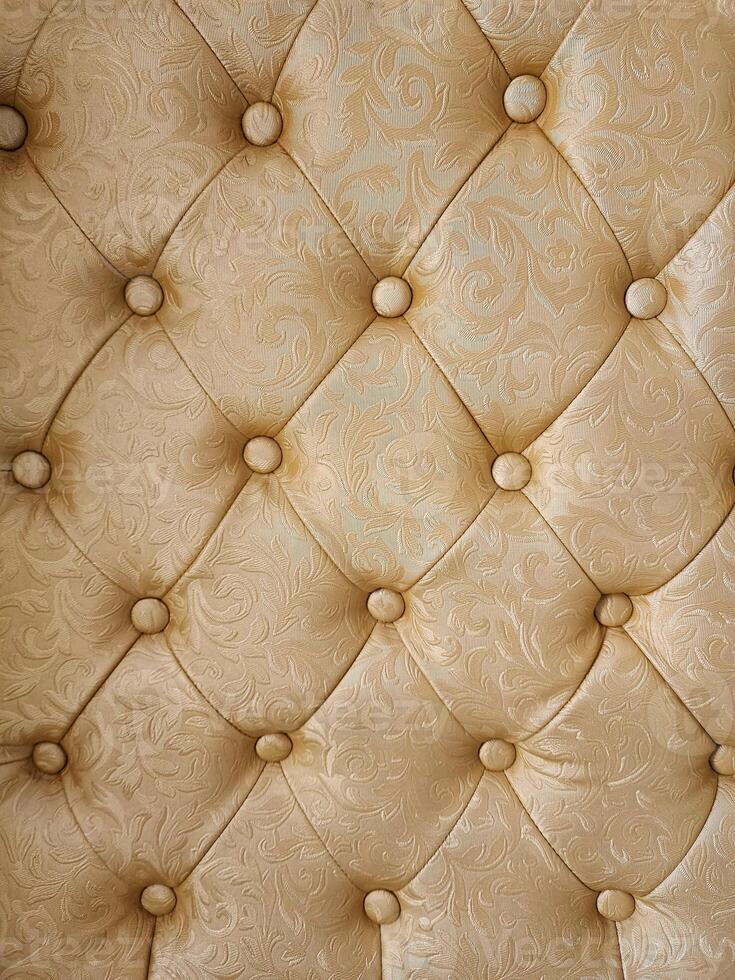 Luxury brown leather upholstery with buttons, closeup photo