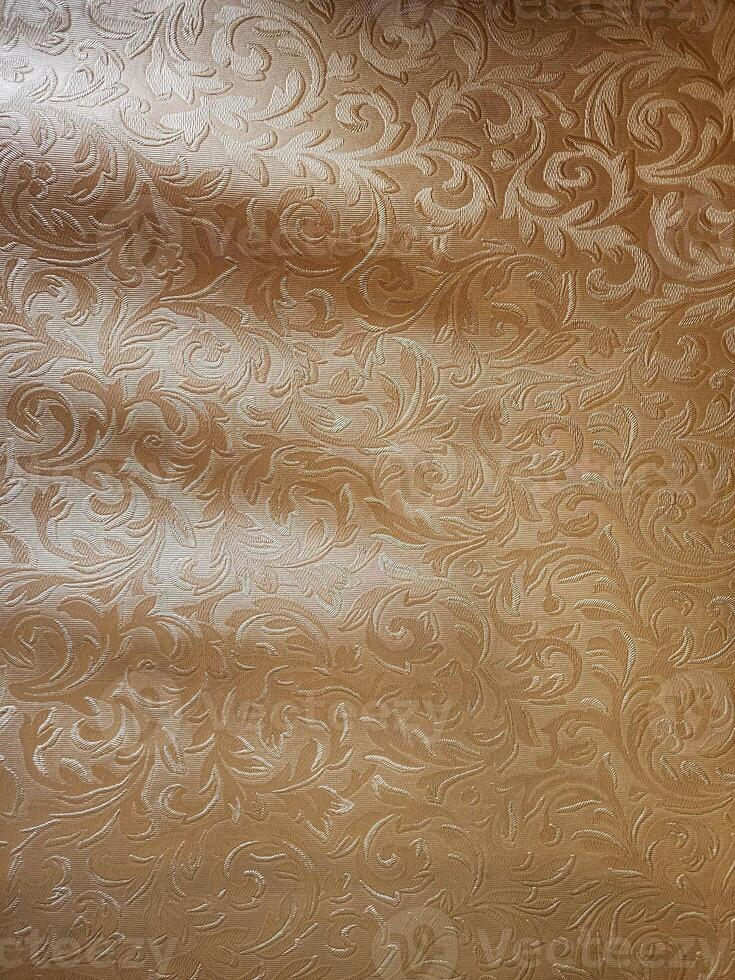 Decorative background with a pattern of curls and swirls in gold photo
