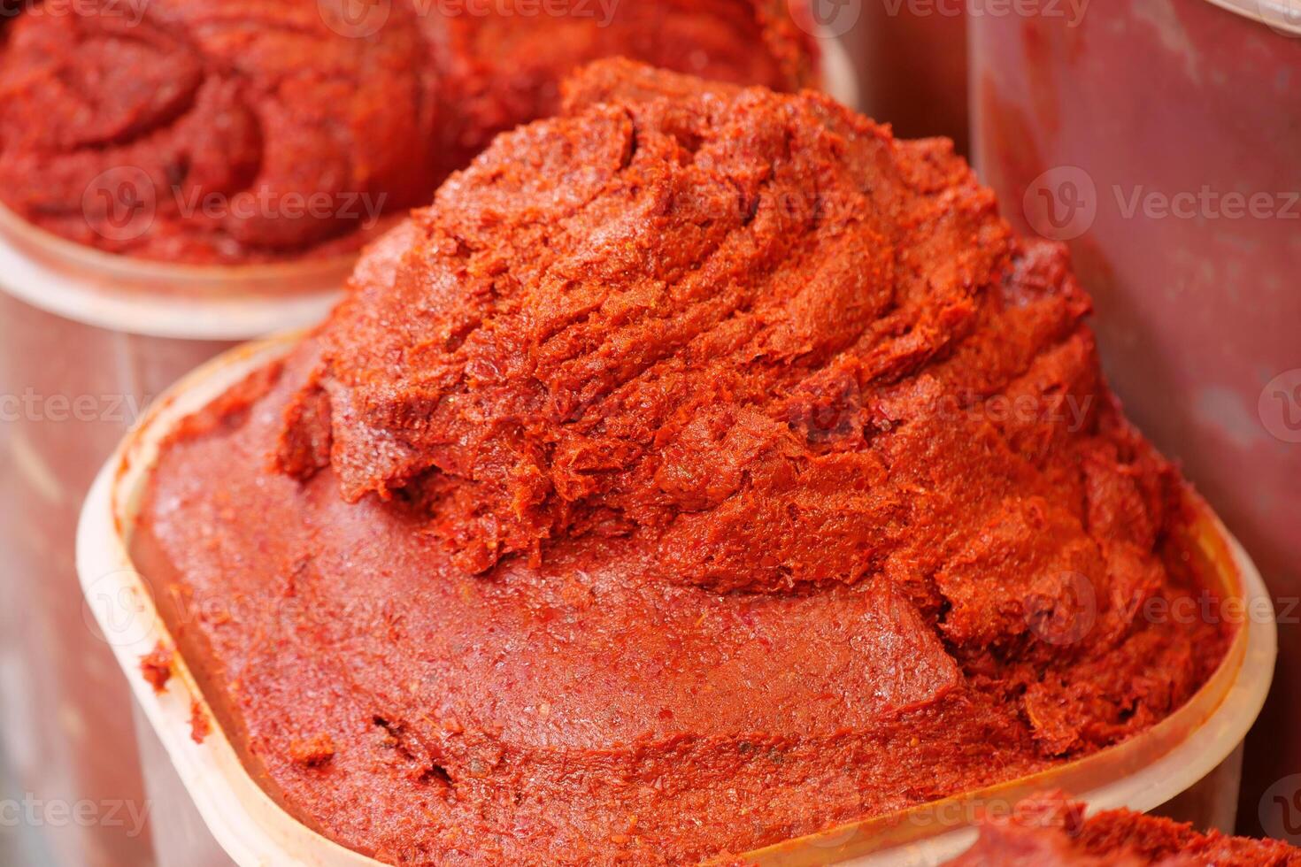 Bright red chili paste displayed at a local market stall photo