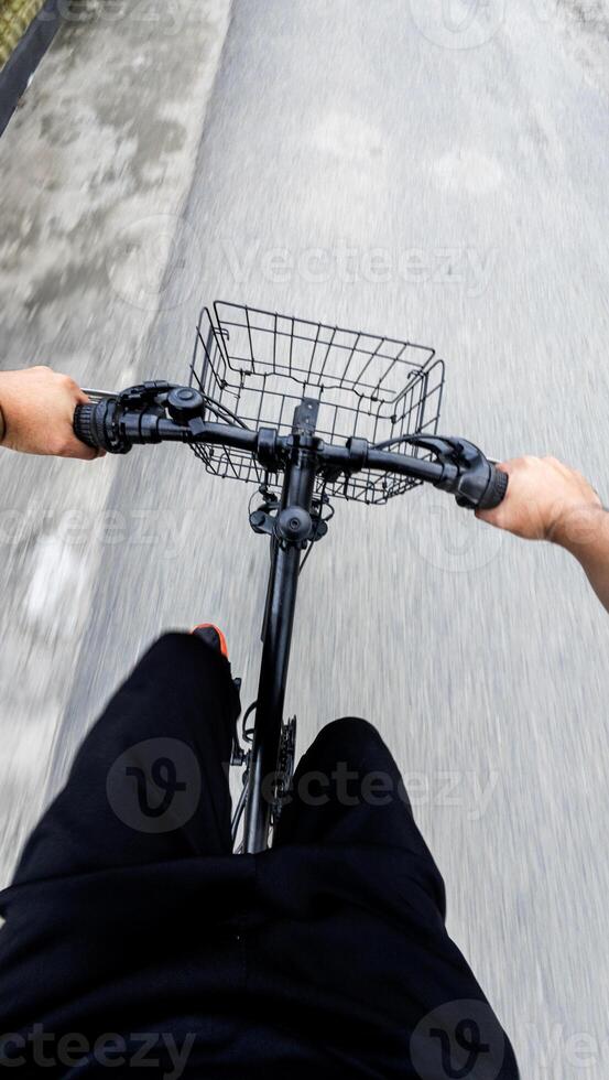 First-Person View of Cyclist Riding Bike on Road photo