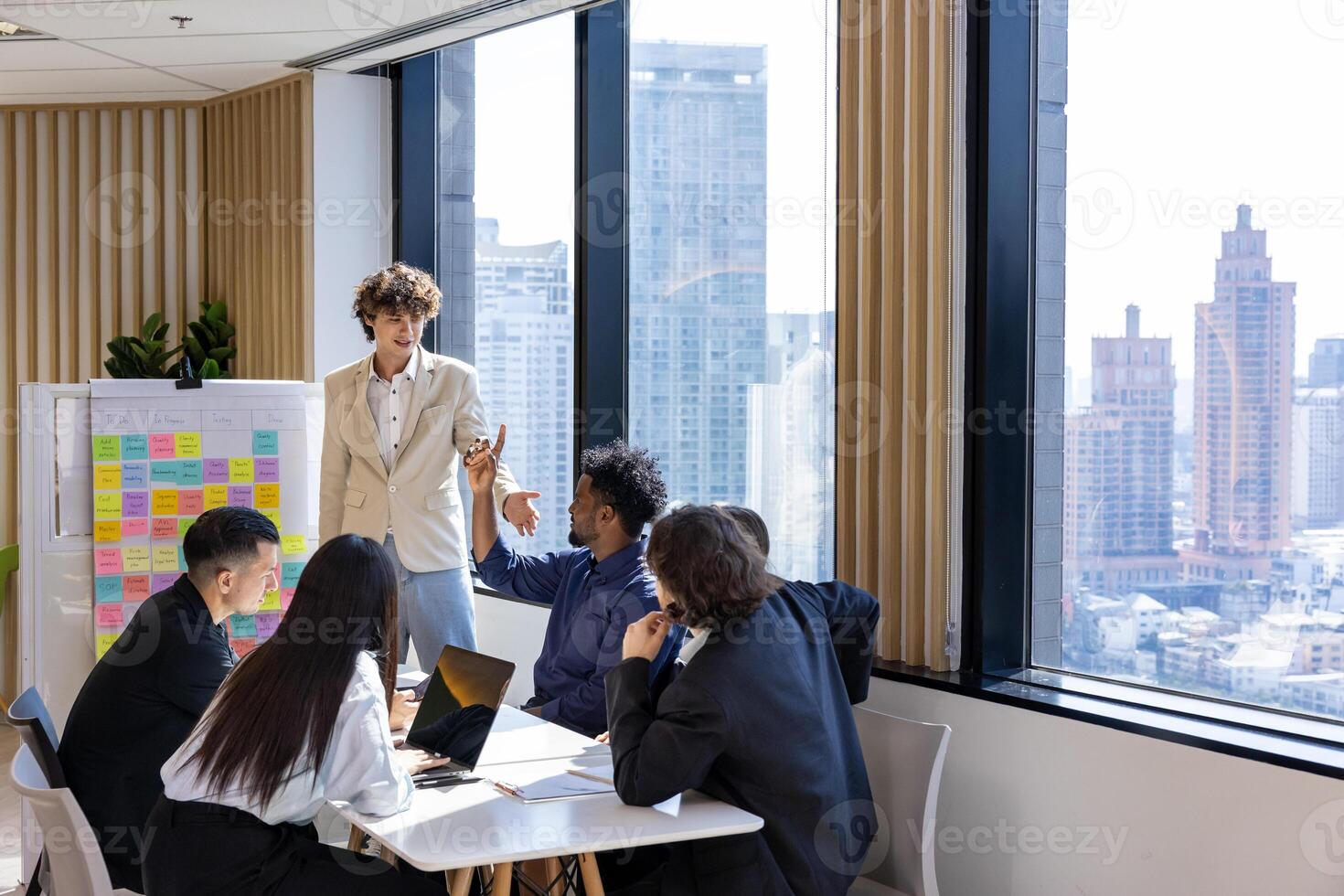 Manager is presenting new project to team while having question from the panel in the executive meeting for next year plan with market share increase for global business and investment photo
