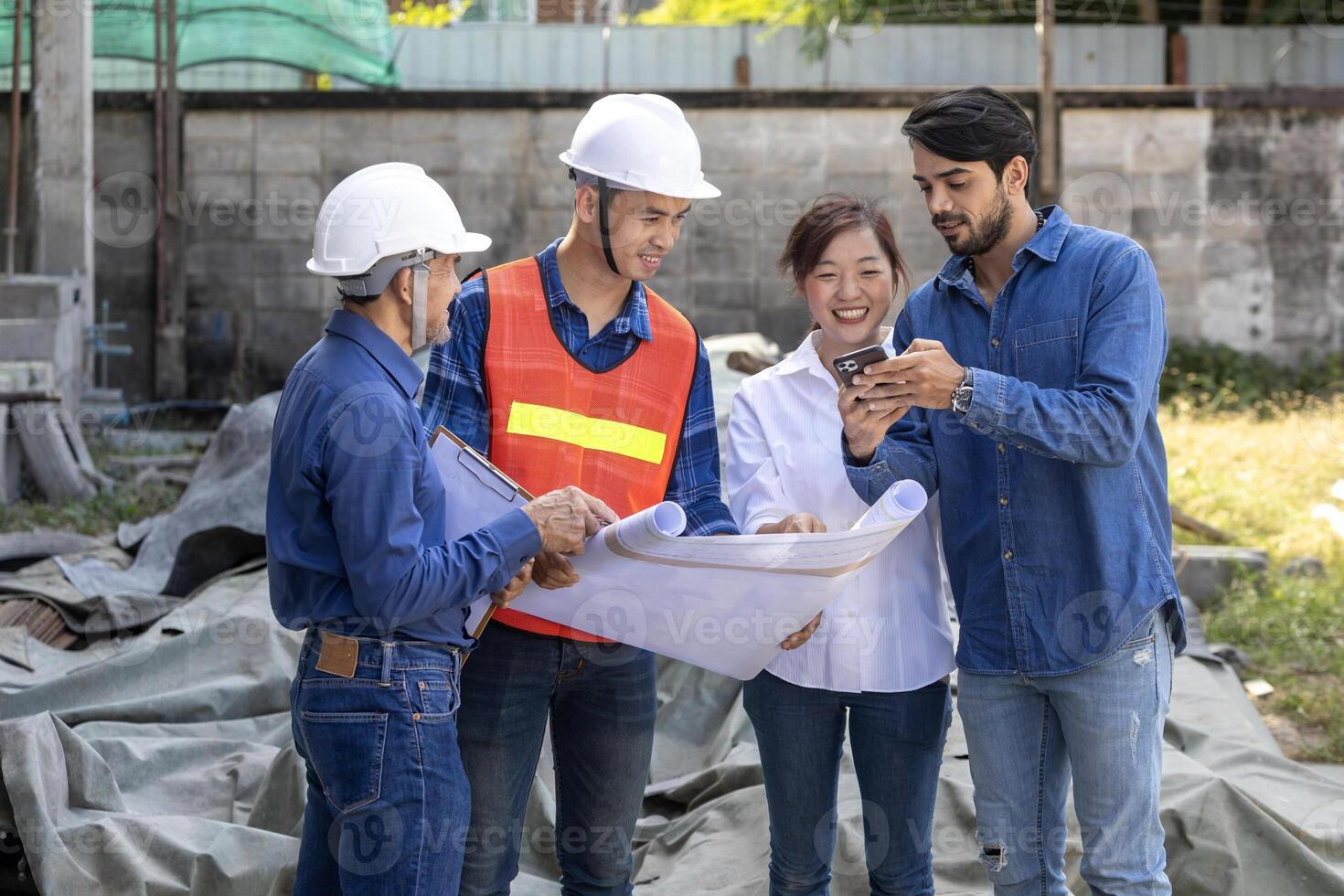 Newly wed couple is meeting with engineering contractor team at their under construction house to inspect the building progress and quality control for home ownership and real estate development photo