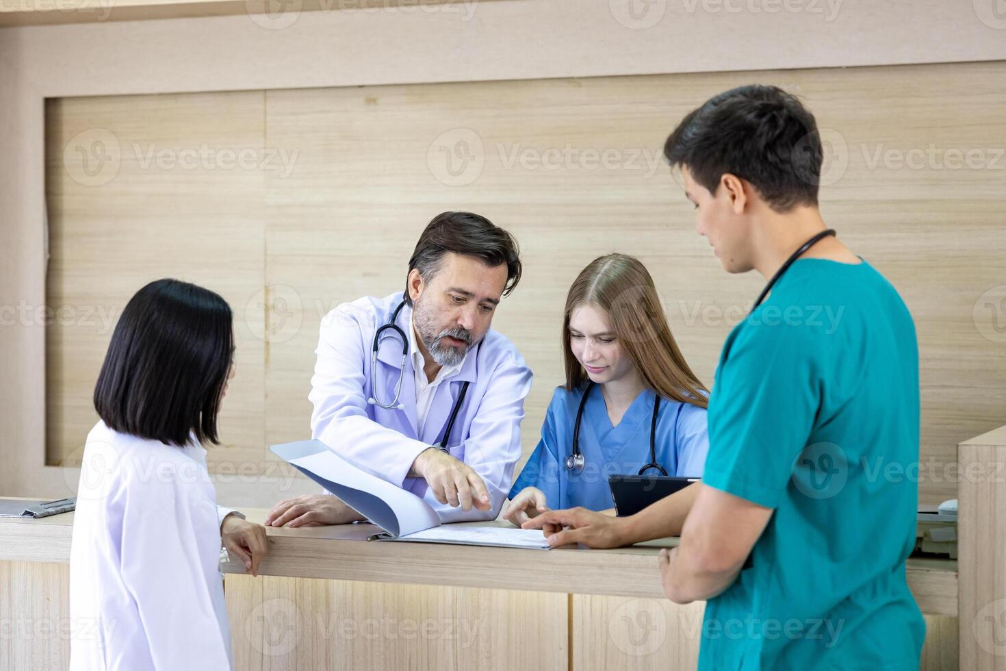 Team of diversity doctor and nurse is discussing and brainstorming over patient medical record after diagnosis for precise care plan with experience senior physician specialist photo