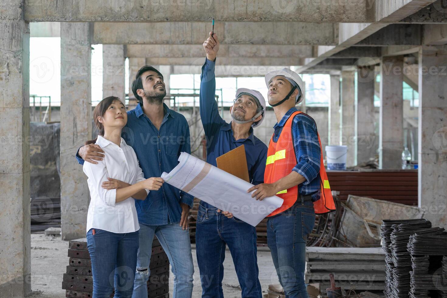 Newly married couple is meeting with engineering contractor at their under construction house to inspect the building progress and quality control for home ownership and real estate development photo
