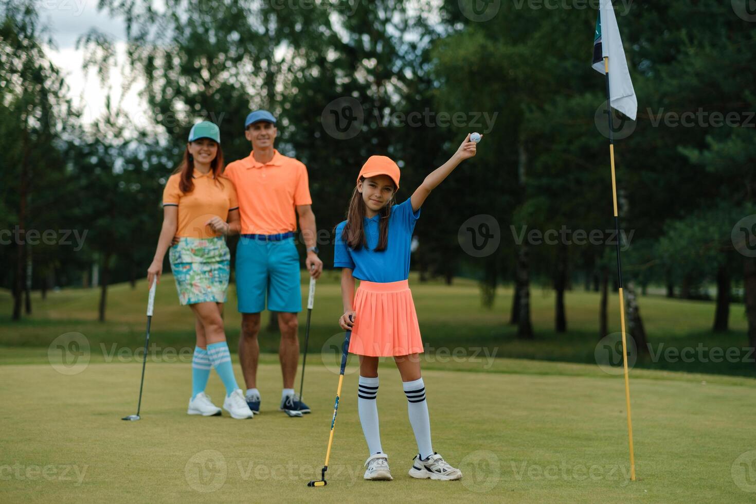 Family enjoys a joyful day of golf activity on a sunny afternoon at a green course with vibrant outfits photo