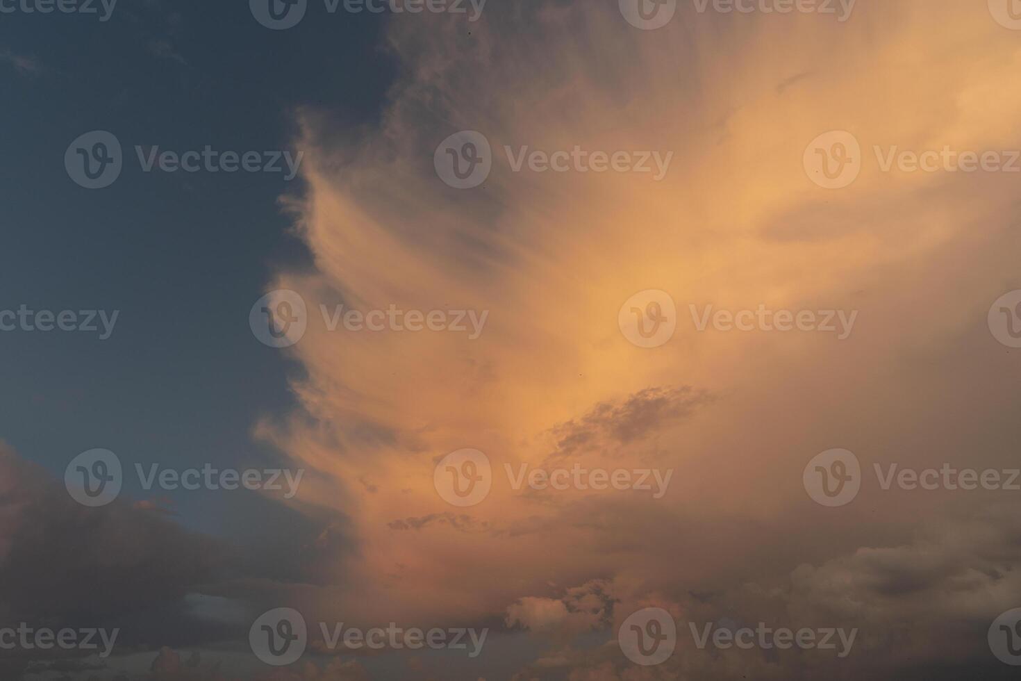 beautiful picture of clouds, feathery clouds in the light of the setting sun fluffy cloud against the blue sky photo