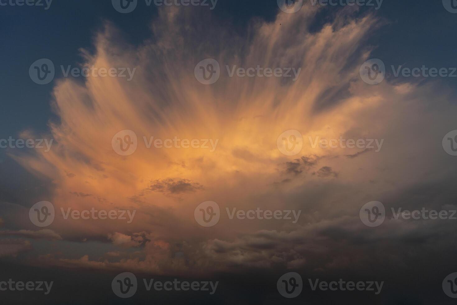 beautiful picture of clouds feathery clouds in the light of the setting sun, fluffy cloud against the blue sky photo