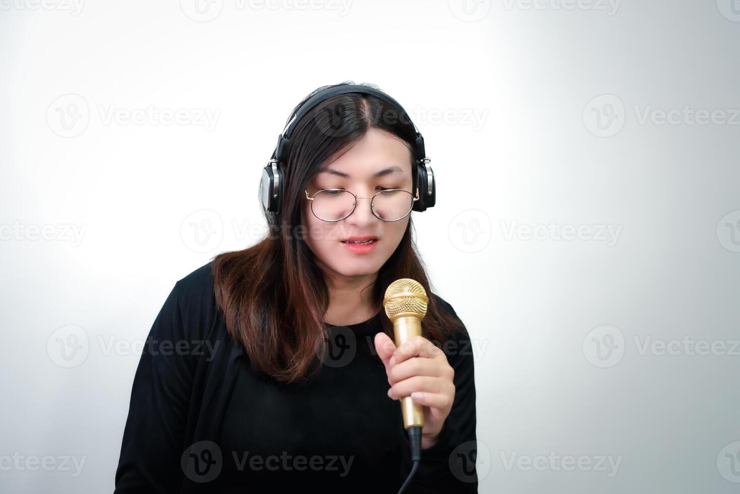 Asian woman singing in a microphone photo