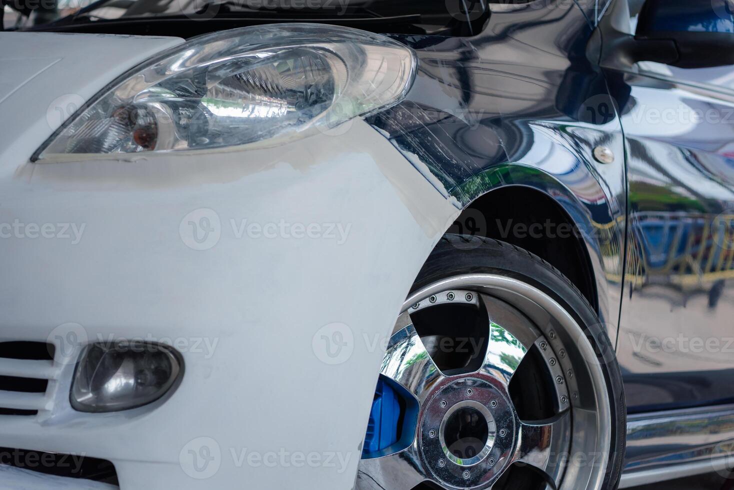 A close up of a white car with a blue rim photo