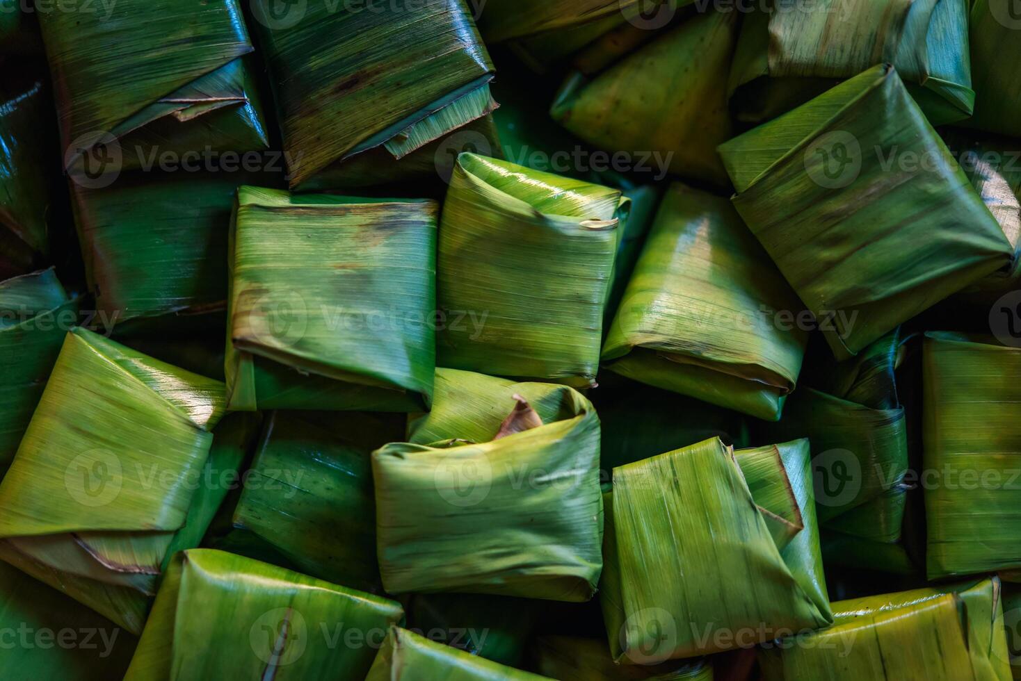 A pile of green leaves wrapped in banana leaves photo