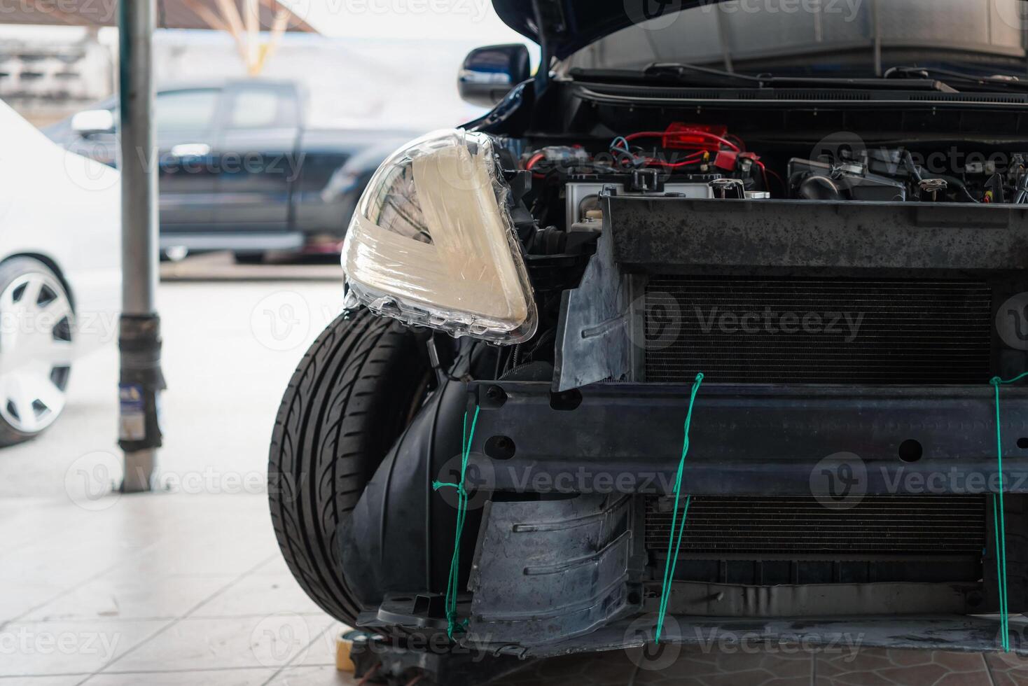 A car with its engine and front end on the ground photo