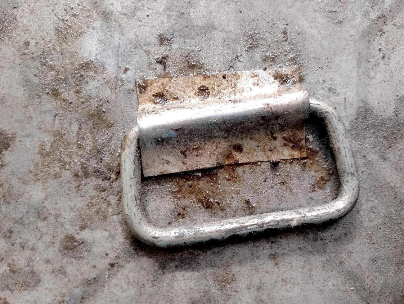 Rusty Metal Handle on Textured Surface photo