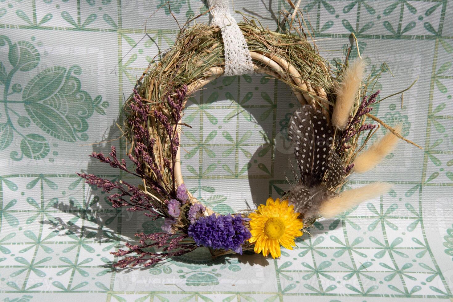 Handcrafted wreath made from dried flowers and herbs, showcasing unique colors and textures, perfect for seasonal decoration in home or celebration space photo