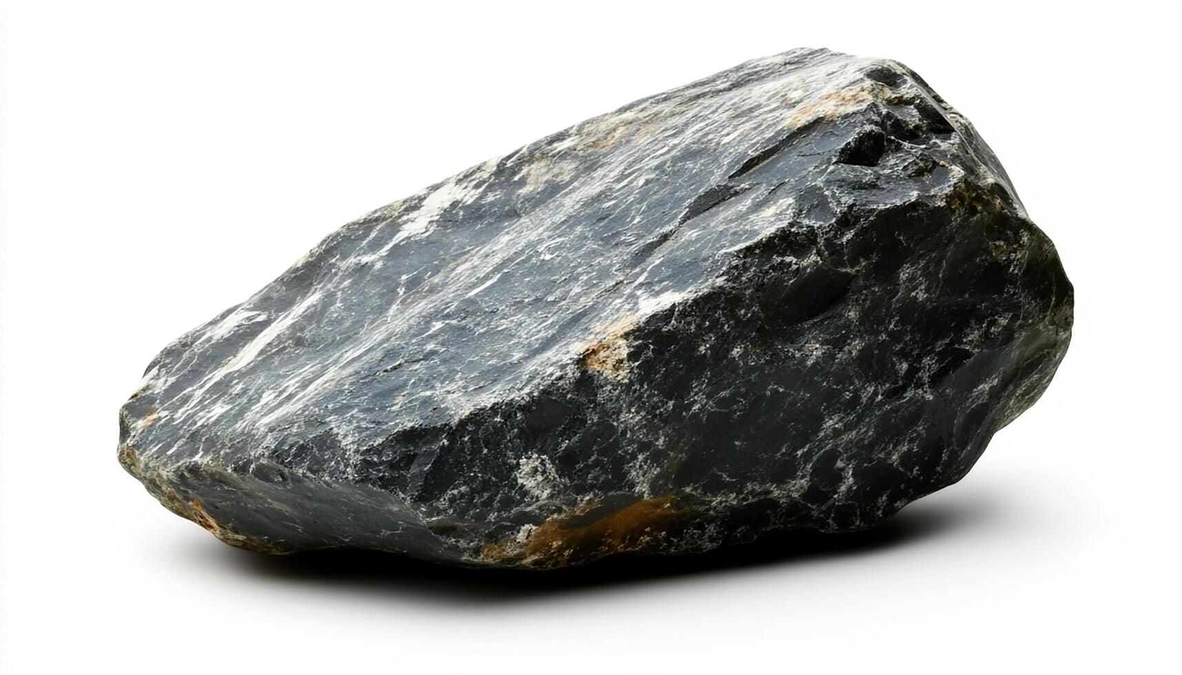A dark gray rock with rough edges and a smooth surface isolated on a white background view photo