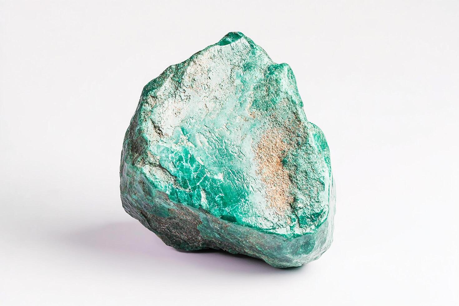 Close up shot of a rough malachite stone specimen against a plain white background surface photo