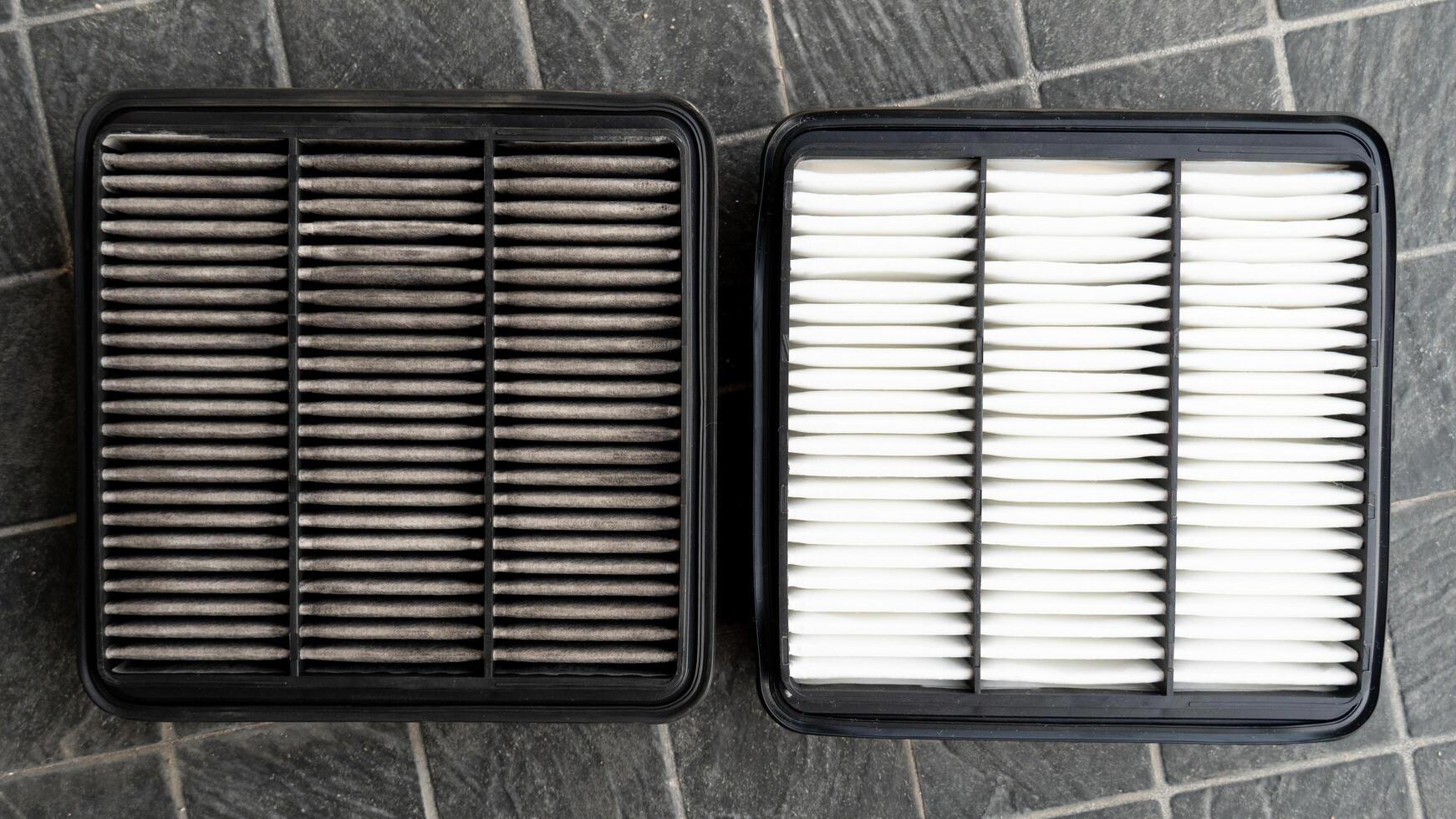 Front of old and new filters. Comparison between new and old is different. Placed on a black tiled floor. photo