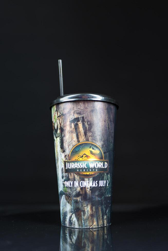 Bangkok, Thailand - July 12, 2025 Soft drink cup with pattern Jurassic World Rebirth from theater in Thailand, Major Cineplex. photo
