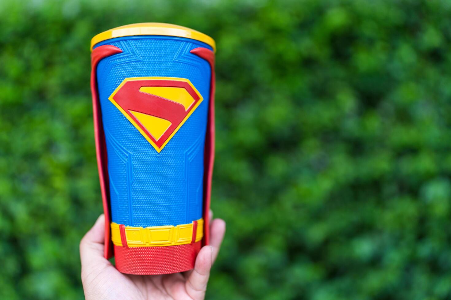 Bangkok, Thailand - July 12, 2025 A cup of ice drink with a Superman pattern on hand from Major Cineplex. photo