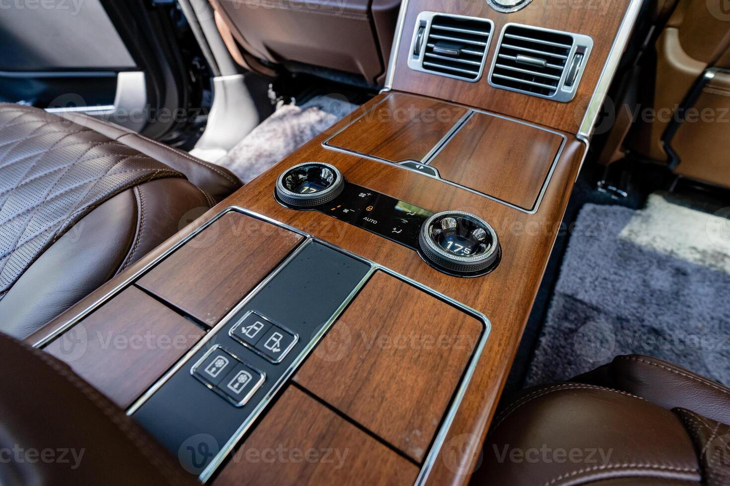Experience the elegance of a luxury car interior featuring a beautifully crafted wooden console along with stateoftheart climate controls designed for ultimate comfort and convenience photo