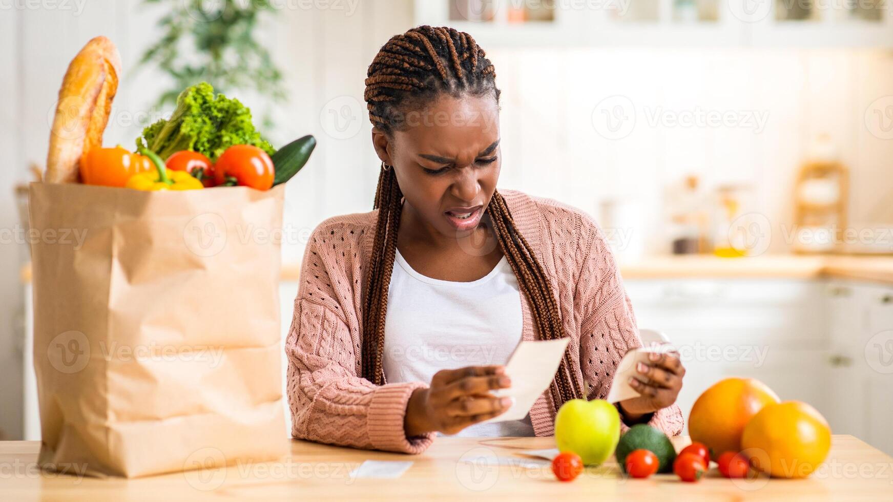 Woman checking grocery receipt with frustration photo