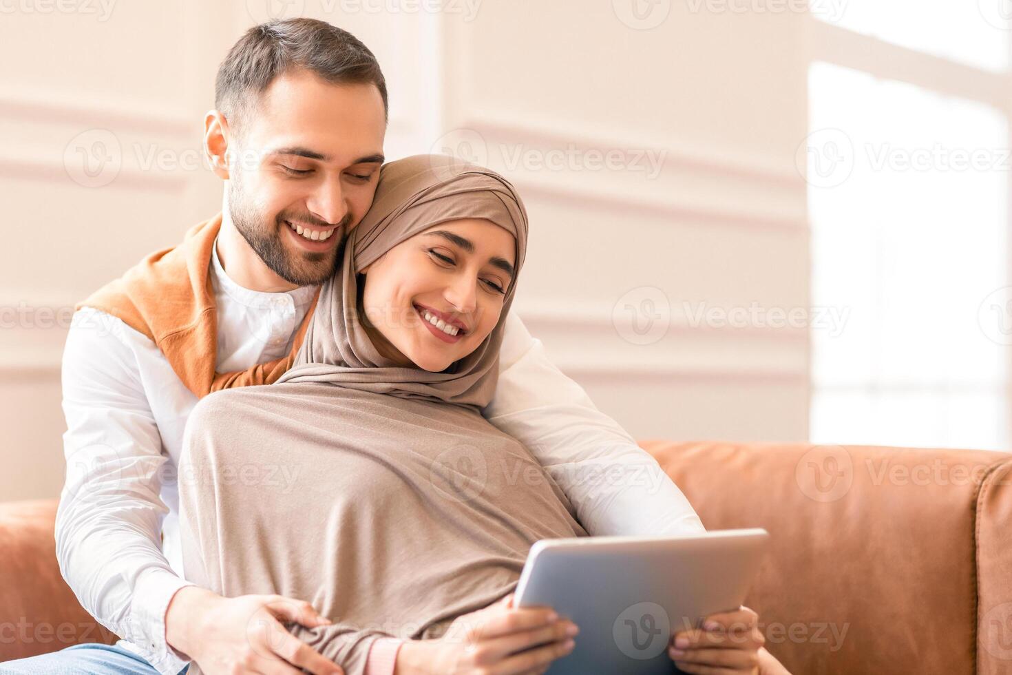 Happy couple using a tablet together photo