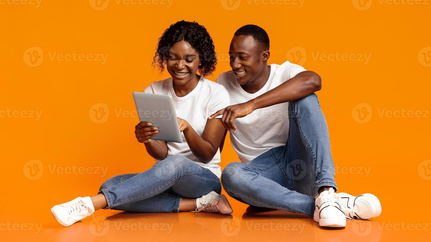 Happy couple with tablet photo