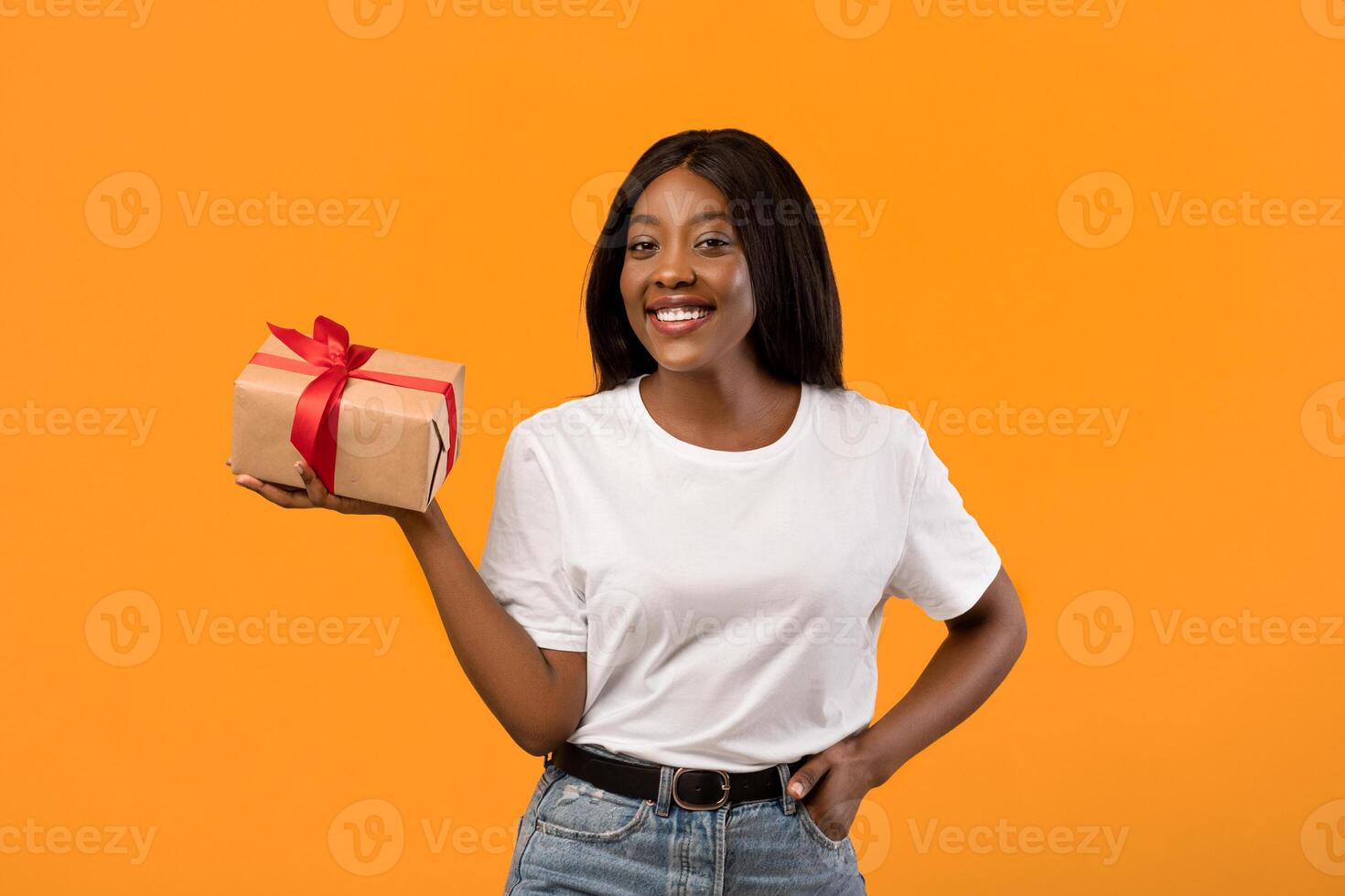 Woman with a gift box and red ribbon photo