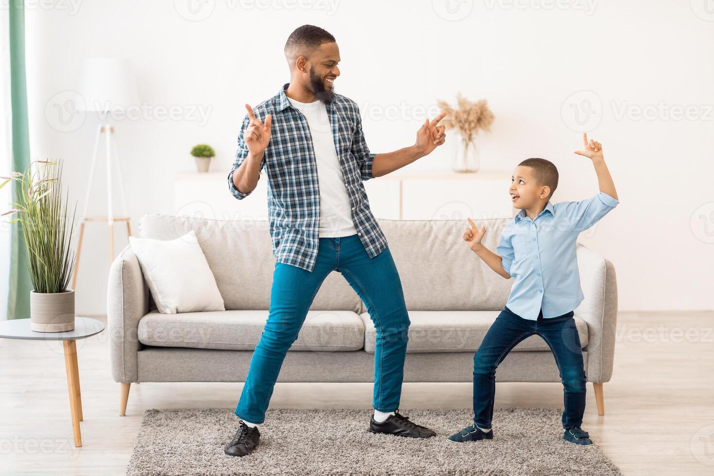 Dad and son dancing joyfully photo