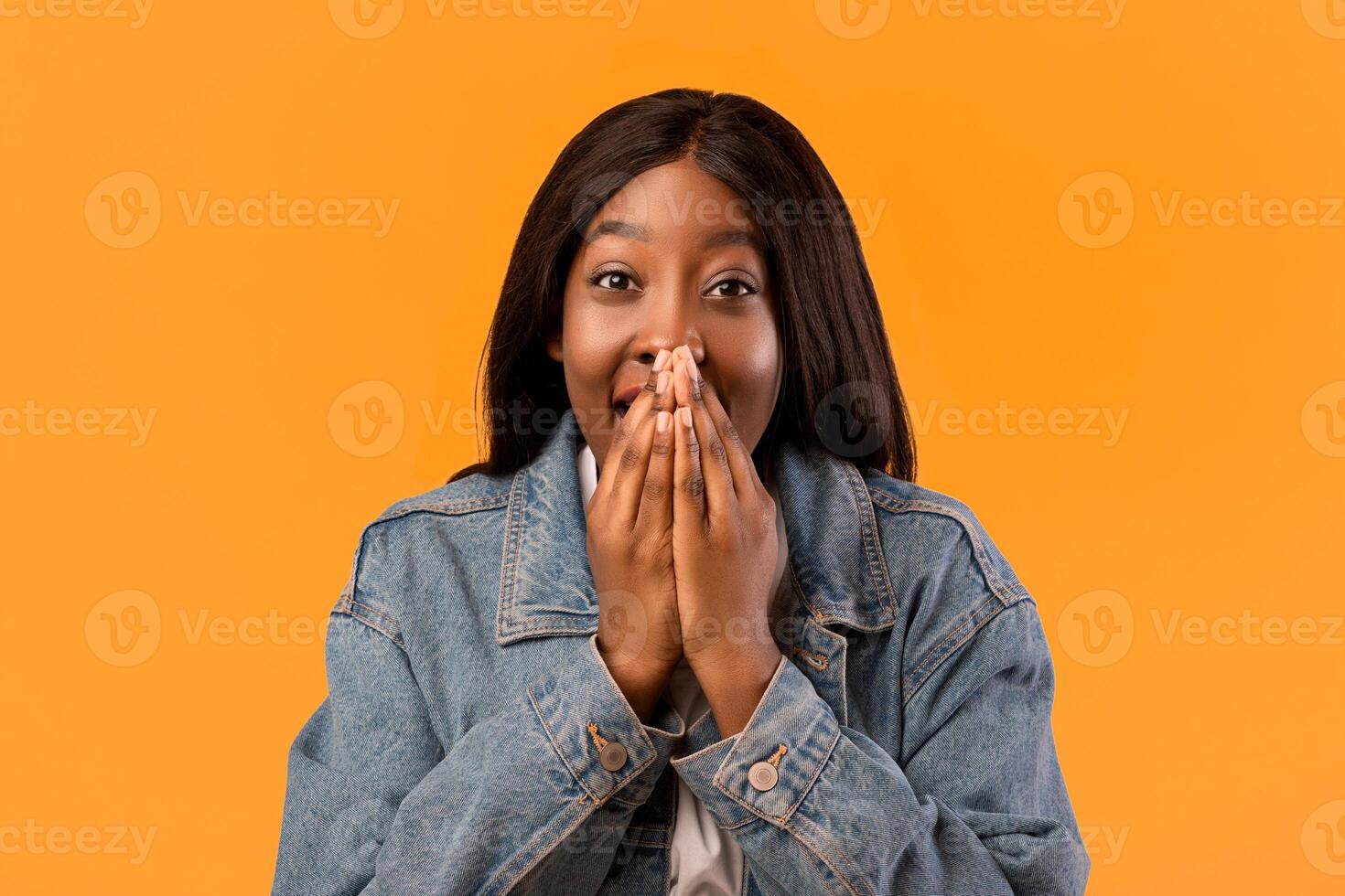 Surprised woman in denim jacket photo