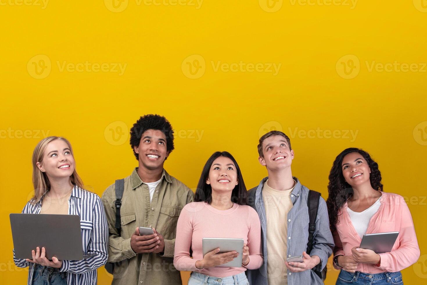 Group of young adults with devices photo