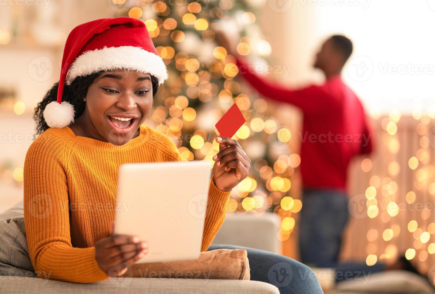Woman celebrating holiday with online shopping photo