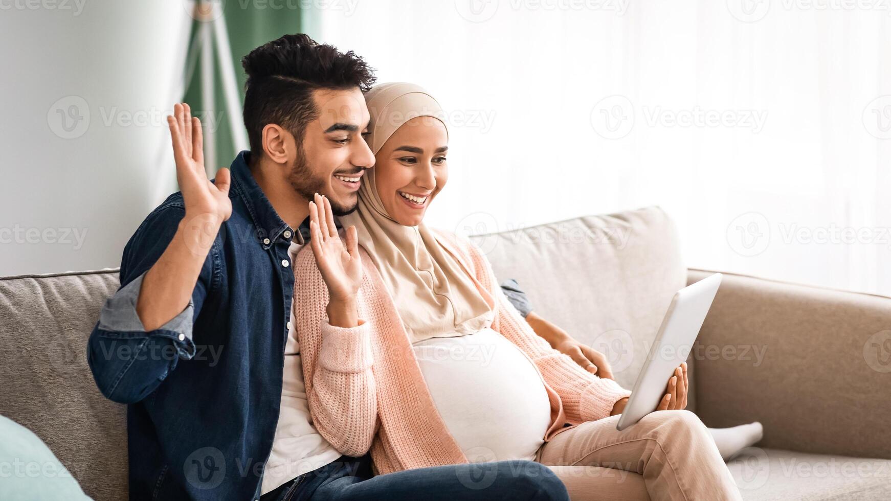 Couple enjoying video call during pregnancy photo