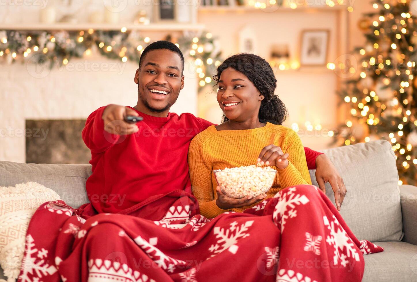 Couple watching TV with popcorn photo