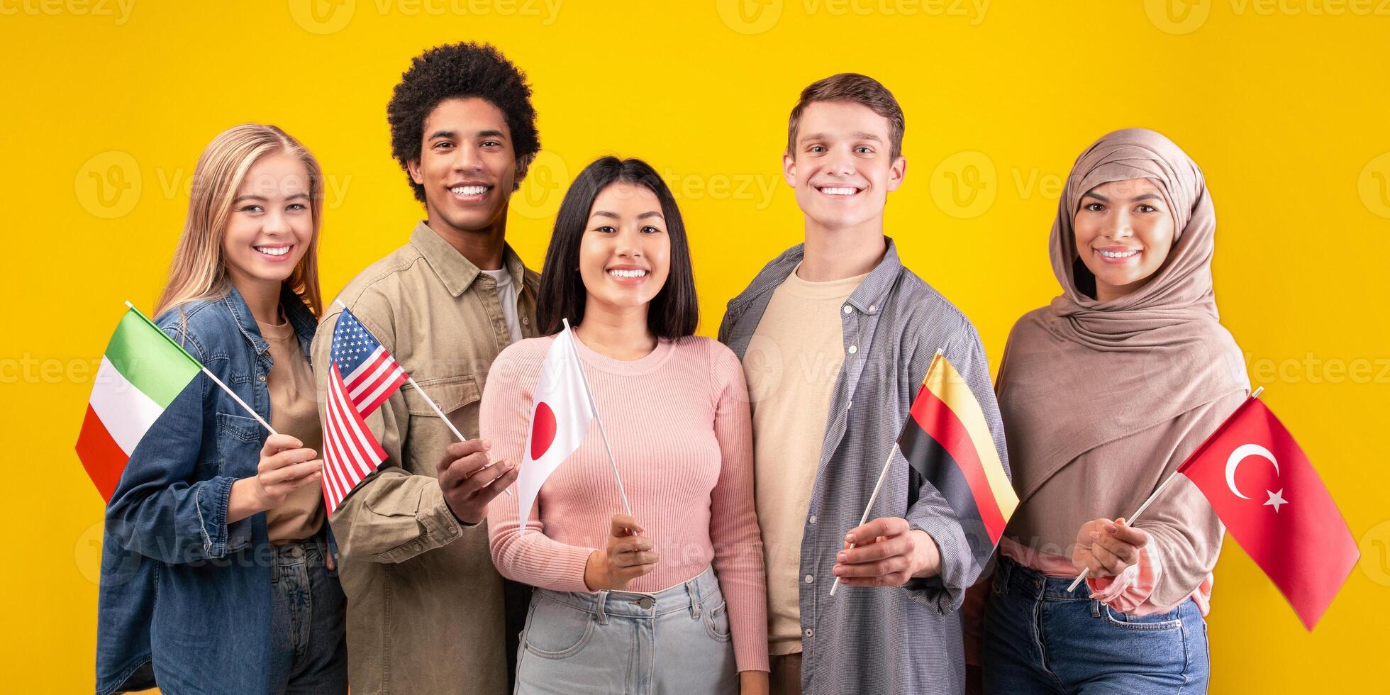 Friends holding international flags together photo