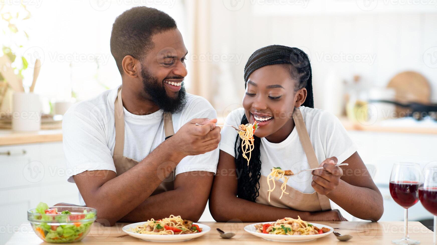 Couple enjoying pasta at home photo