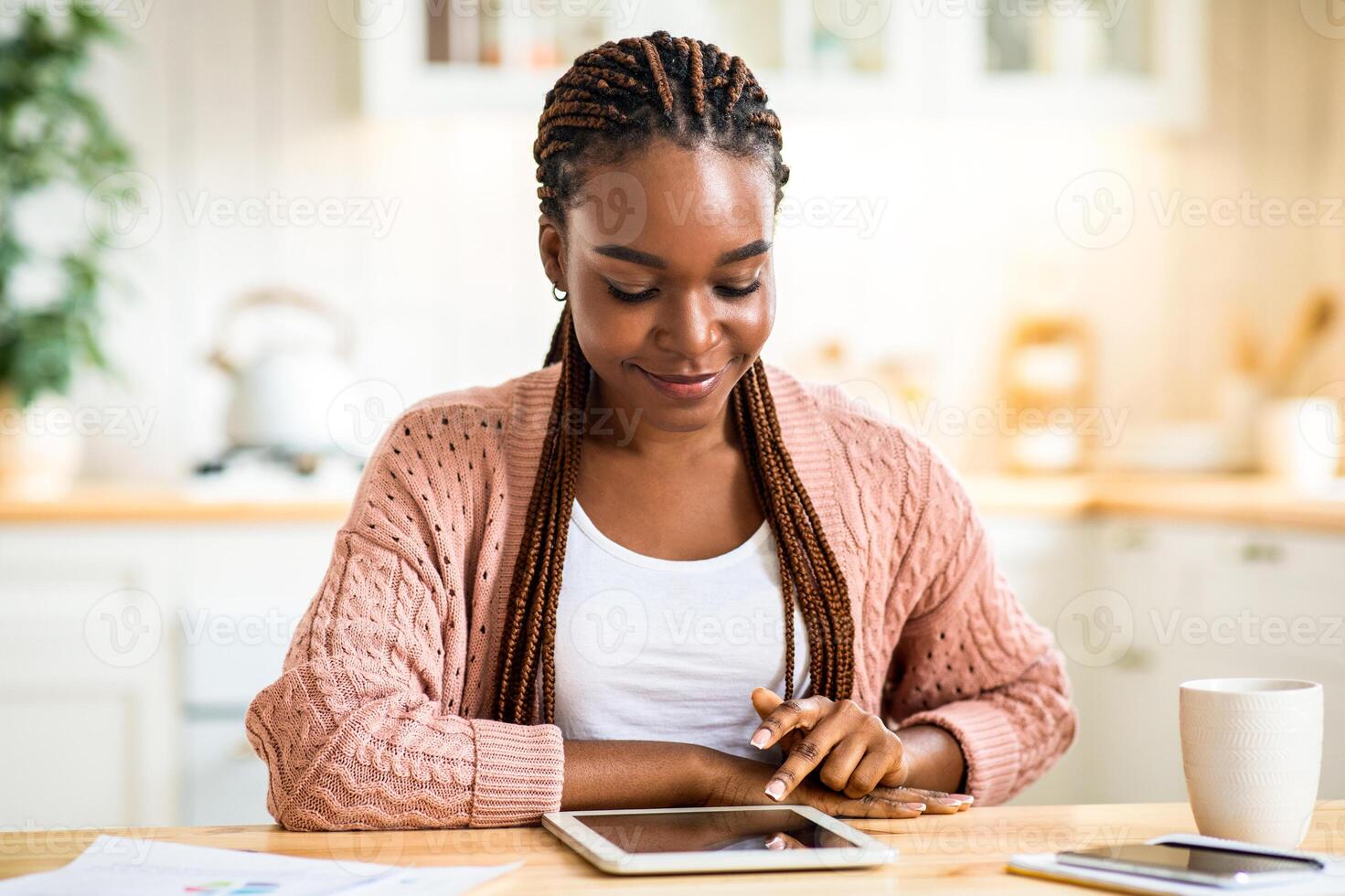 Portrait Of Smiling Young Black Female Relaxing With Digital Tablet In Kitchen, Happy Millennial African American Woman Using Modern Gadget For Working Remotely At Home Or Study Online, Free Space photo