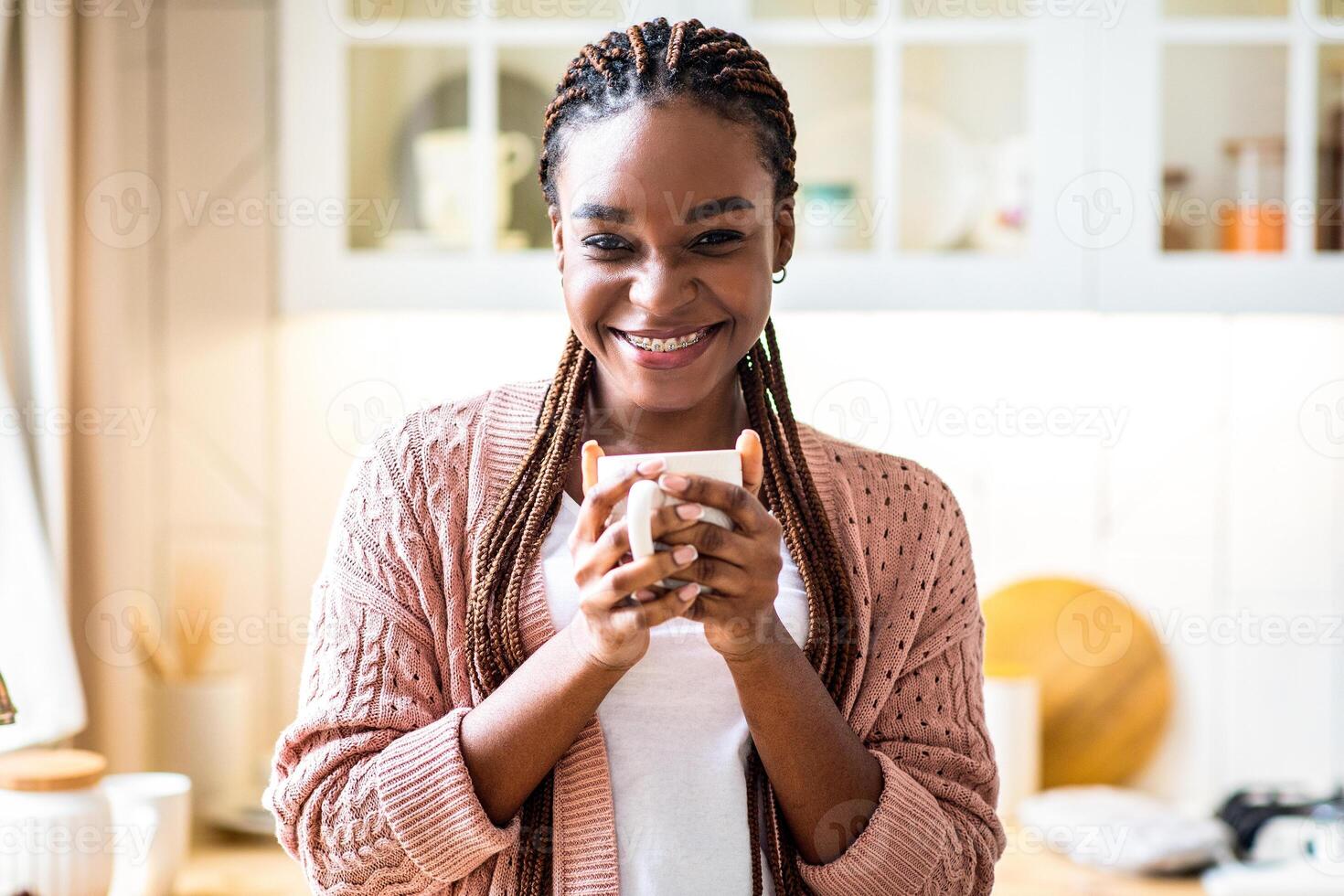 Woman smiling with coffee in kitchen photo