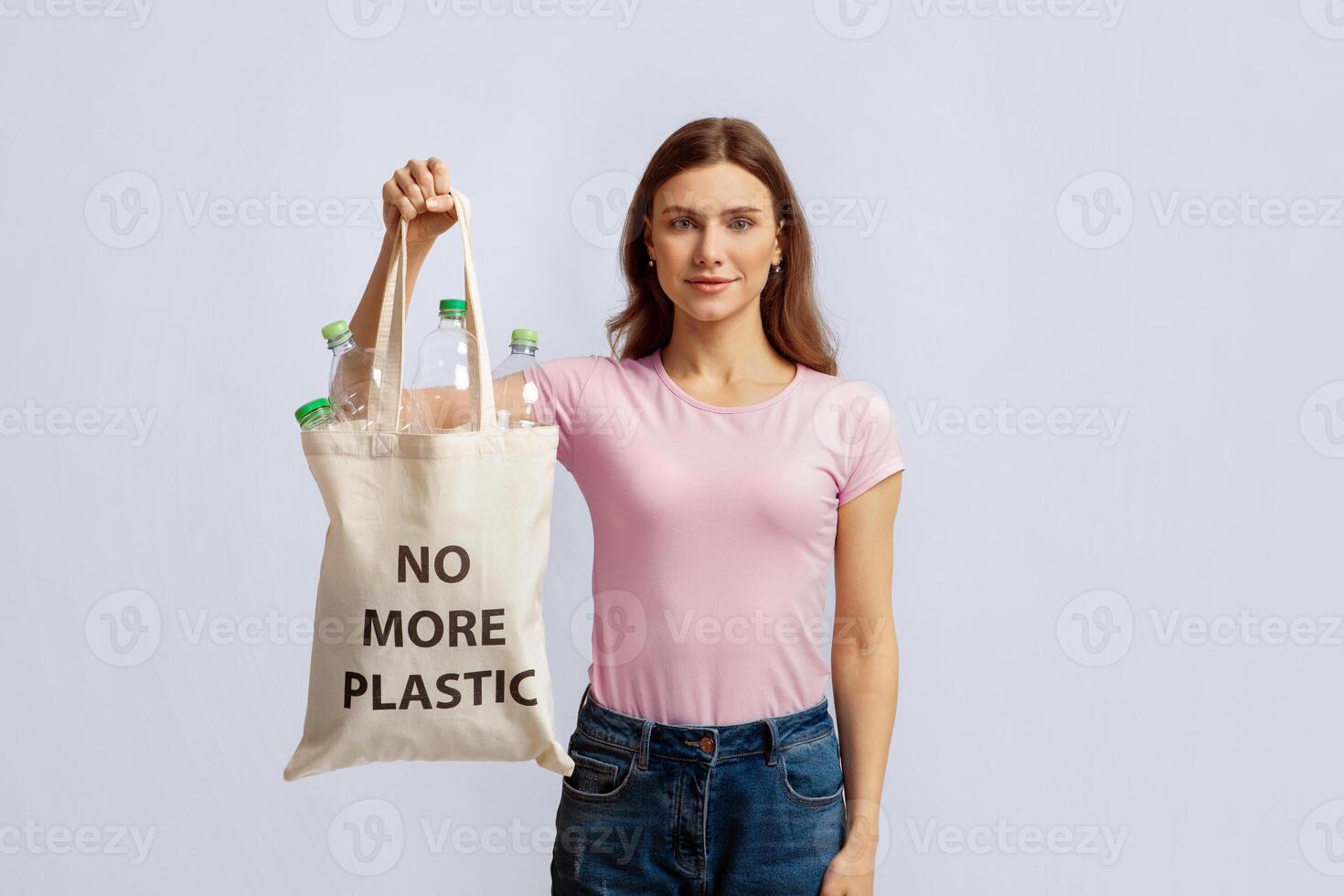 Woman holding bag with plastic bottles photo