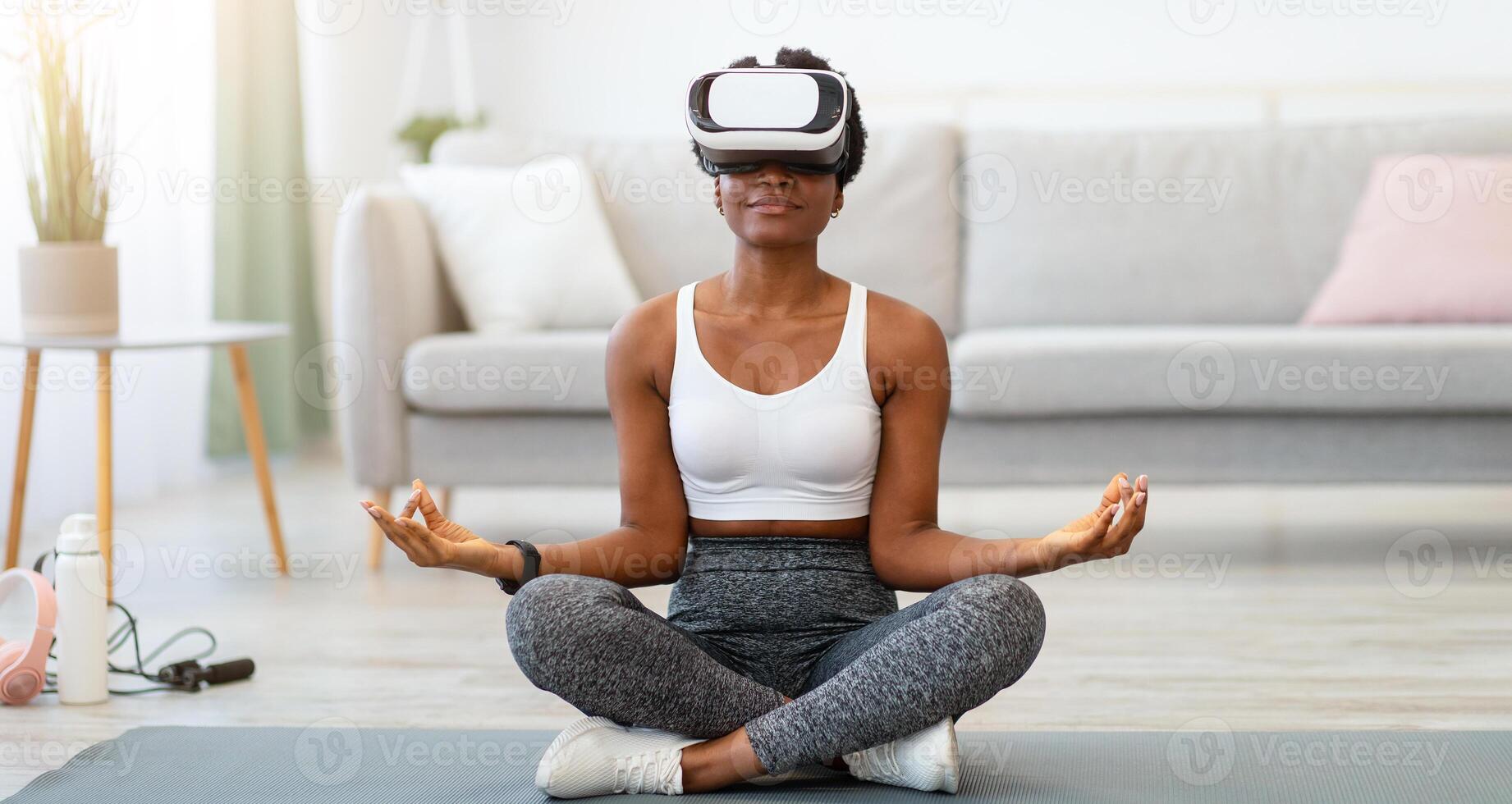 Woman meditating with virtual reality headset photo