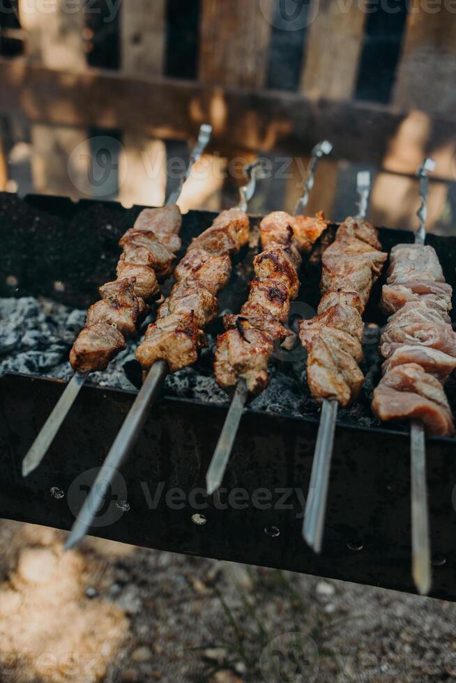 Delicious grilled meat on a barbecue. Close up. Picnic menu. photo