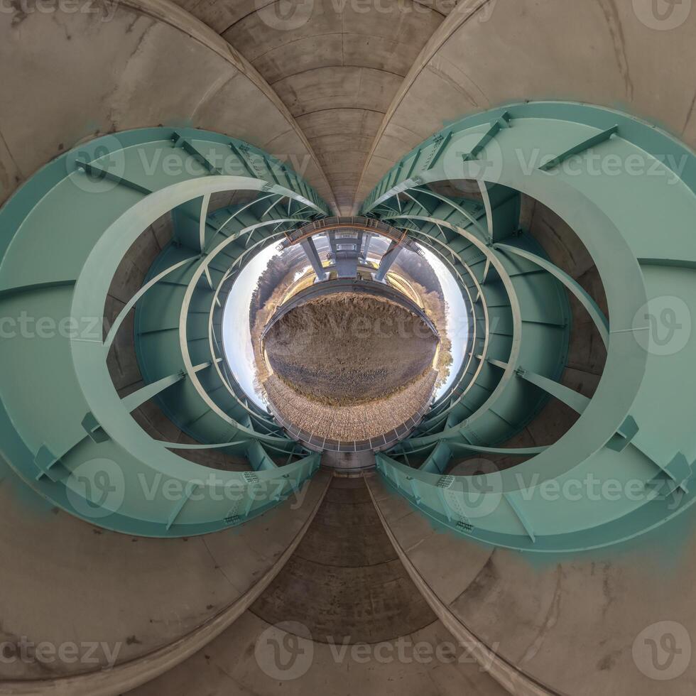 A view of a circular structure with a blue sky photo