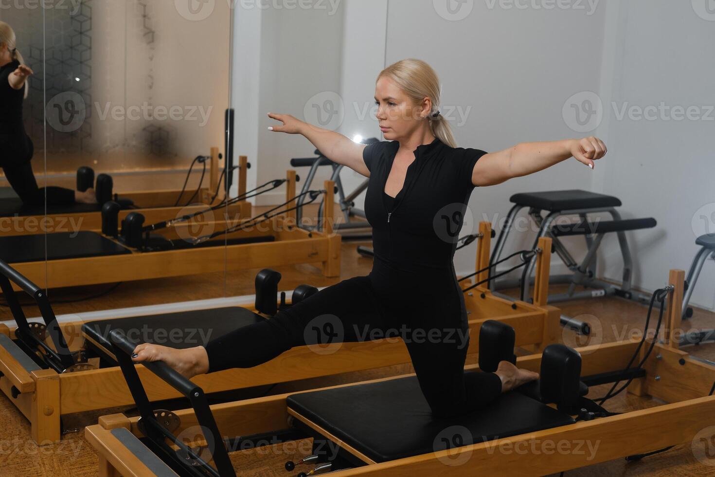 Fitness enthusiast practicing pilates exercises in a modern studio during a serene morning session photo