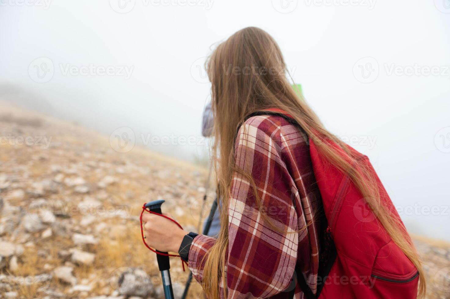 Hiker Exploring Foggy Mountain Trail on a Misty Morning with Backpack photo