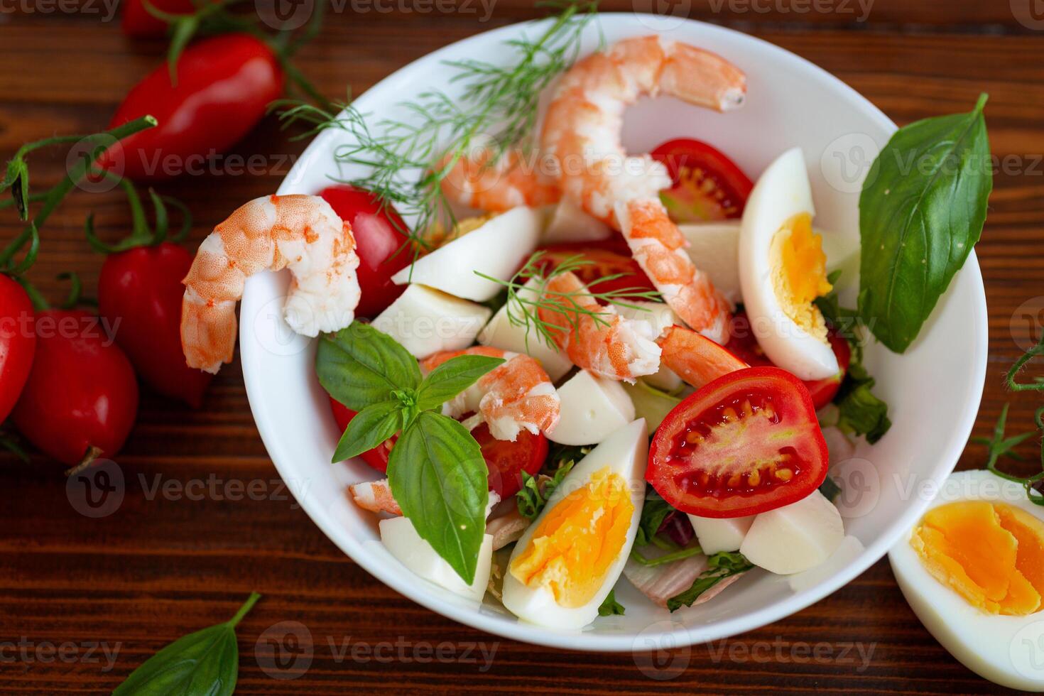 Salad with protein and greens on a wooden board photo
