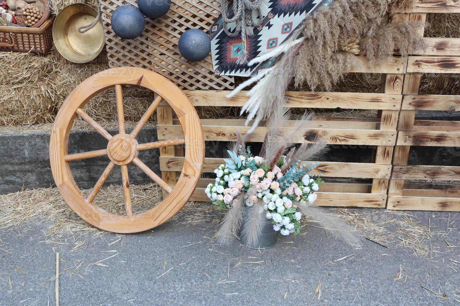 Beautiful Rustic Decor Featuring a Wooden Wheel with an Attractive Floral Arrangement photo