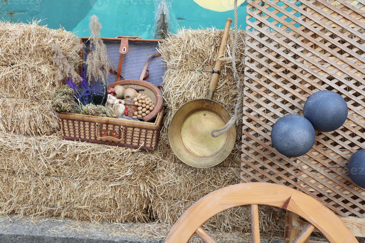 A Rustic Farm Display Featuring Straw Bales Alongside a Collection of Vintage Items and Decorations photo
